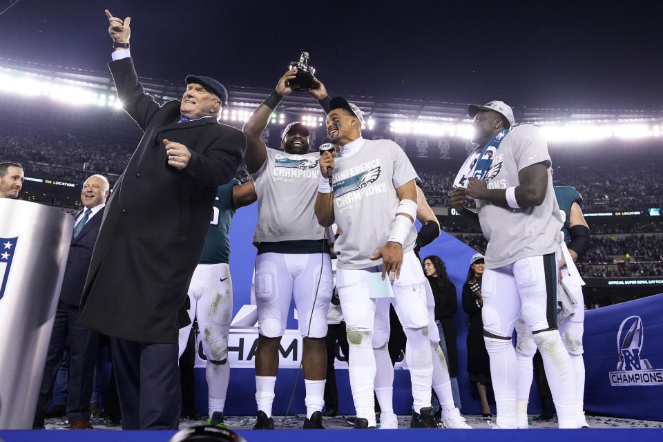 Terry Bradshaw, left, stands on stage with Philadelphia Eagles players from left, Fletcher Cox, Jalen Hurts and A.J. Brown after the NFC Championship NFL football game between the Philadelphia Eagles and the San Francisco 49ers on Sunday, Jan. 29, 2023, in Philadelphia. The Eagles won 31-7. (AP Photo/Matt Slocum)