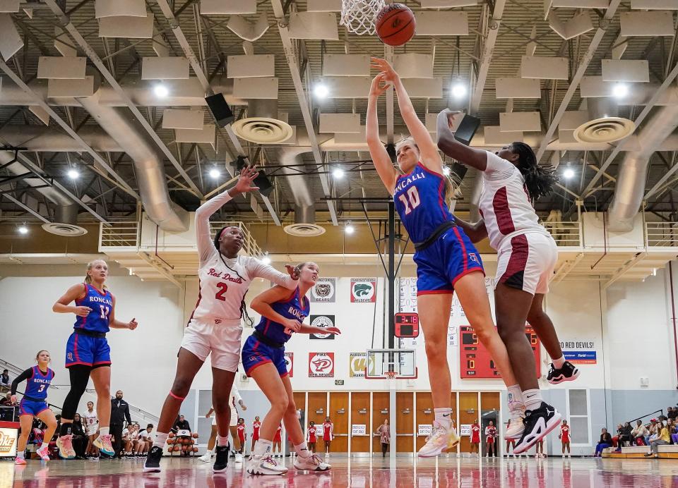 Roncalli Royals center Lydia Stahley (10) reaches for a rebound Tuesday, Nov. 14, 2023, during the game at Pike High School in Indianapolis.