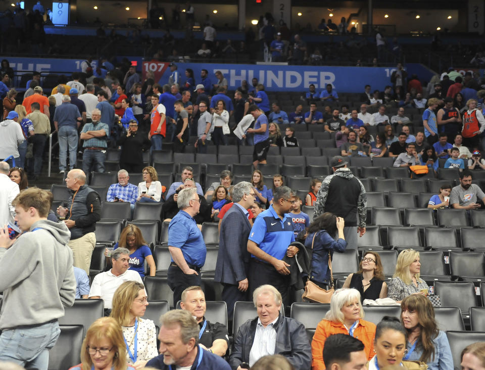 Basketball fans clear out after it is announced that an NBA basketball game between Oklahoma City Thunder and Utah Jazz in Oklahoma City has been postponed, Wednesday, March 11, 2020. (AP Photo/Kyle Phillips)