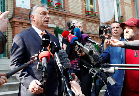 Hungarian Prime Minister Viktor Orban talks to the media after casting his ballot during the European Parliament Elections in Budapest, Hungary, May 26, 2019. REUTERS/Bernadett Szabo