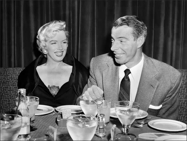 AFP/Getty Marilyn Monroe and then-husband Joe DiMaggio having dinner together in the 1950s.