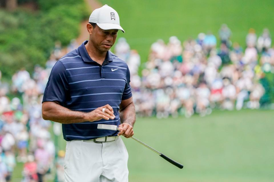 April 7: Tiger Woods reacts to his putt on the sixth green during the second round of the Masters.