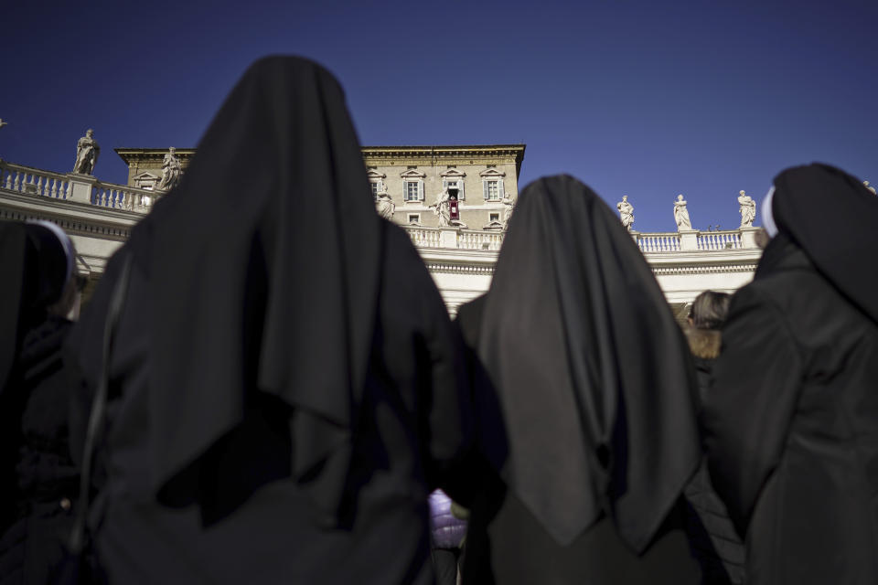 Nuns watch Pope Francis as he delivers his blessing during the Angelus noon prayer he recited from the window of his studio overlooking St. Peter's Square, at the Vatican, Thursday, Dec. 26, 2019. (AP Photo/Andrew Medichini)