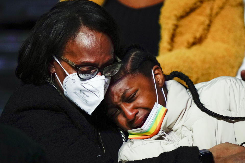 Mourners embrace during funeral services for the victims of a deadly row house fire, at Temple University in Philadelphia, Monday, Jan. 17, 2022. Officials say it's the city's deadliest single fire in at least a century. (AP Photo/Matt Rourke)