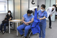 Medical workers wait to receive the first dose of the Pfizer BioNTech COVID-19 vaccine at the National Medical Center vaccination center in Seoul Saturday, Feb. 27, 2021. (Song Kyung-Seok/Pool Photo via AP)