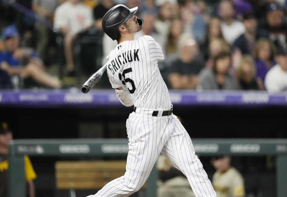 Colorado Rockies' Randal Grichuk follows the flight of his solo home run off San Diego Padres starting pitcher Sean Manaea in the third inning of a baseball game Friday, Sept. 23, 2022, in Denver. (AP Photo/David Zalubowski)