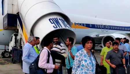 Passengers stand on the tarmac after an emergency landing, due to lost cabin pressure, on a Jet Airways flight, in Mumbai, India September 20, 2018 in this still image obtained from social media video. Melissa Tixiera via REUTERS