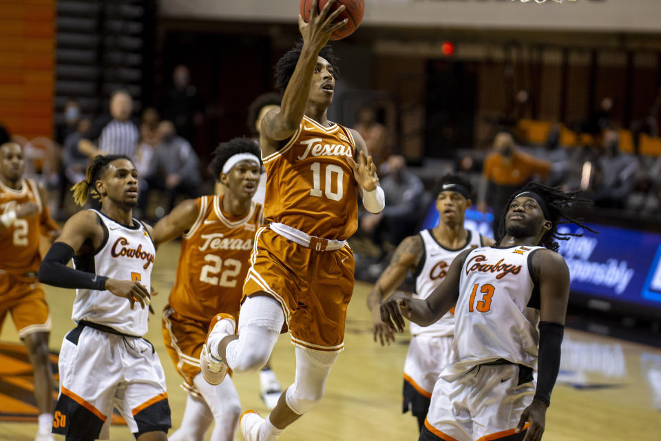 Texas guard Donovan Williams (10) drives the lane during the first half of the NCAA college basketball game against Oklahoma State in Stillwater, Okla., Saturday, Feb. 6, 2021. (AP Photo/Mitch Alcala)