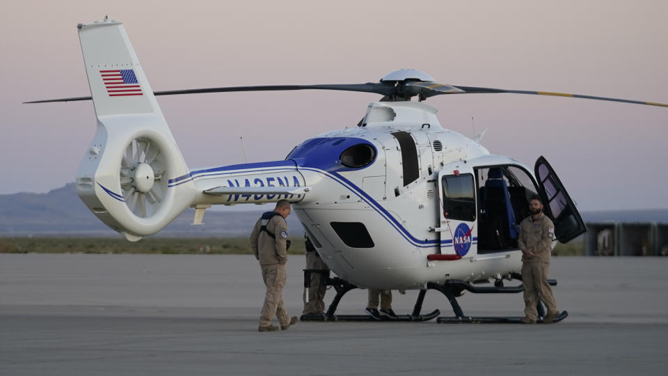 A NASA helicopter waits for the arrival of a space capsule carrying NASA's first asteroid samples on Sunday, Sept. 24, 2023, to a temporary clean room at Dugway Proving Ground, in Utah. The Osiris-Rex spacecraft released the capsule following a seven-year journey to asteroid Bennu and back. (AP Photo/Rick Bowmer)
