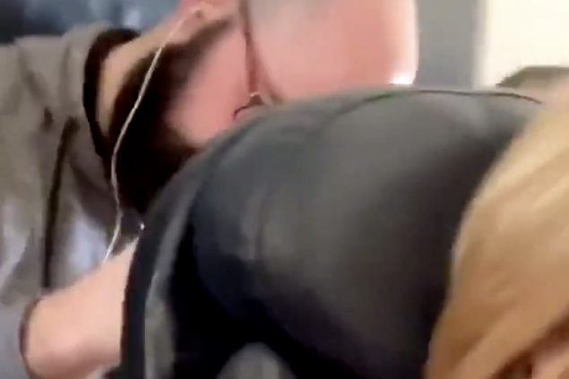 Footage of a woman being 'punched' by a male passenger onboard an American Airlines flight has gone viral: Twitter.com/AmicaAli