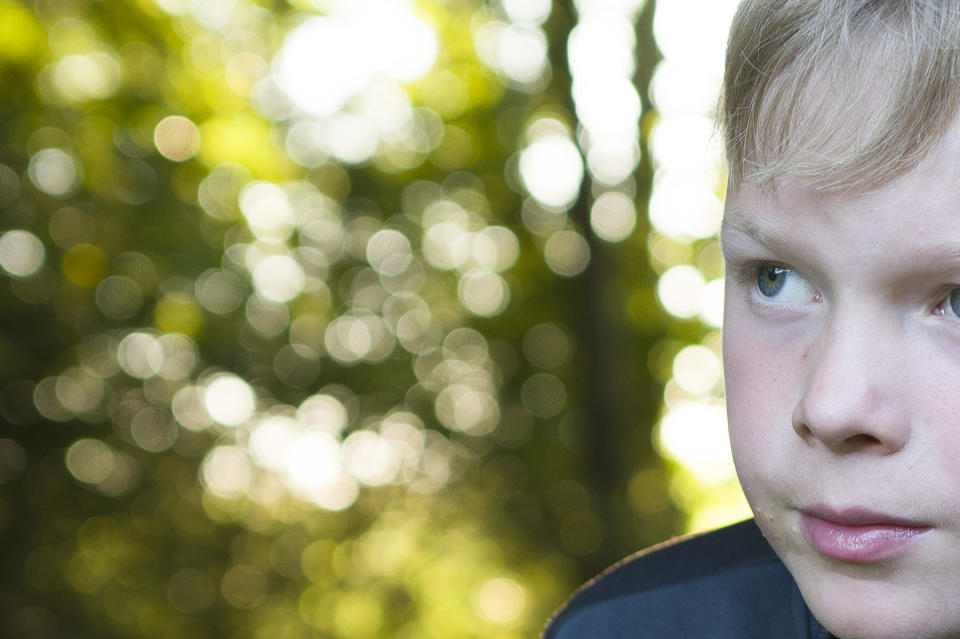 Close up of outdoors portrait taken with the Leica Q3 showing bokeh detail in tree-dappled sunset background