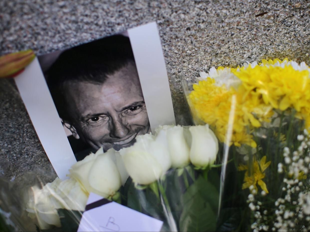 <p>An image of French restaurateur Baptiste Lormand is pictured alongside floral tributes outside the French embassy in Mexico City</p> (Edgard Garrido/Reuters)