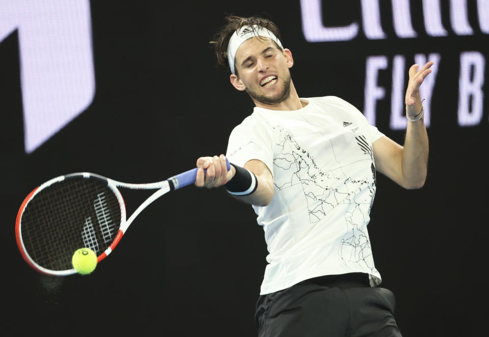 Austria's Dominic Thiem plays a shot during his third round match against Australia's Nick Kyrgios at the Australian Open tennis championship in Melbourne, Australia, Friday, Feb. 12, 2021.(AP Photo/Hamish Blair)