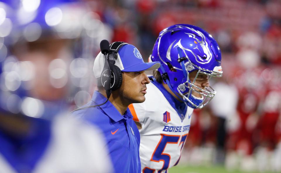 Boise State coach Andy Avalos, center, leads his team against Fresno State during the second half of an NCAA college football game in Fresno, Calif., Saturday, Nov. 6, 2021. (AP Photo/Gary Kazanjian)