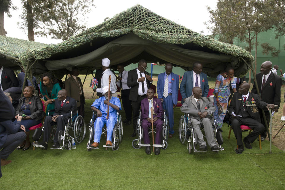 Kenyan World War II veterans and family members wait to meet King Charles III at Kariokor World War II Commonwealth Cemetery in Nairobi, Kenya, Wednesday, Nov. 1, 2023. King Charles III has visited a war cemetery in Kenya, laying a wreath in honor of Kenyans who fought alongside the British in the two world wars. It came a day after the British monarch expressed “greatest sorrow and the deepest regret” for the violence of the colonial era. He gave replacement medals to four war veterans. (Tony Karumba/Pool Photo via AP)