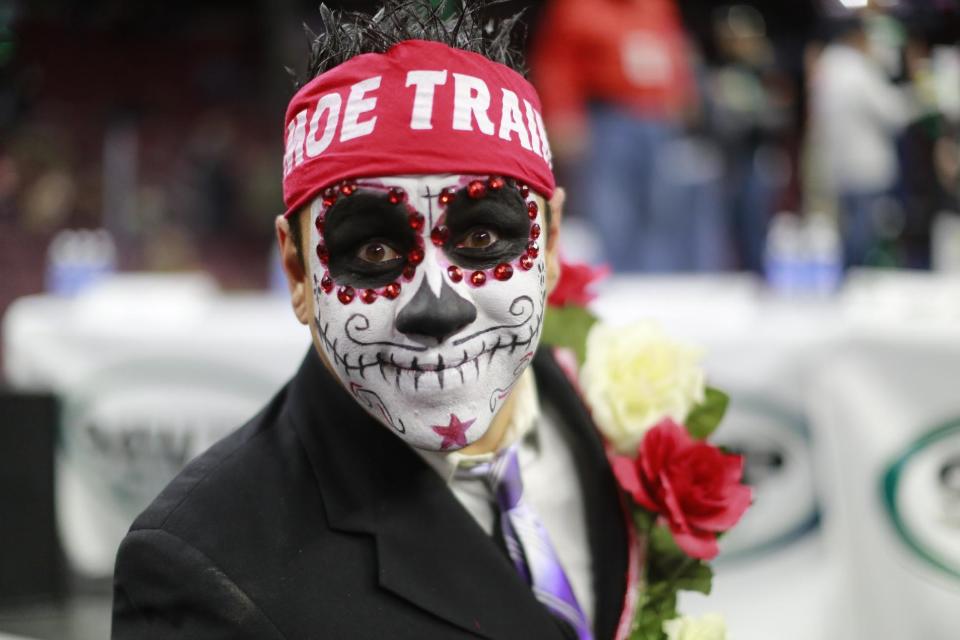 Contestant Moe Train parades at Wing Bowl Friday, Feb. 3, 2017 in Philadelphia. The morning eating ordeal draws boozy spectators who tailgate beforehand outside the city's sports arena to watch flamboyant contestants and suggestively-clad women known as Wingettes. This year, rapper Coolio performed between rounds. (David Swanson/The Philadelphia Inquirer via AP)