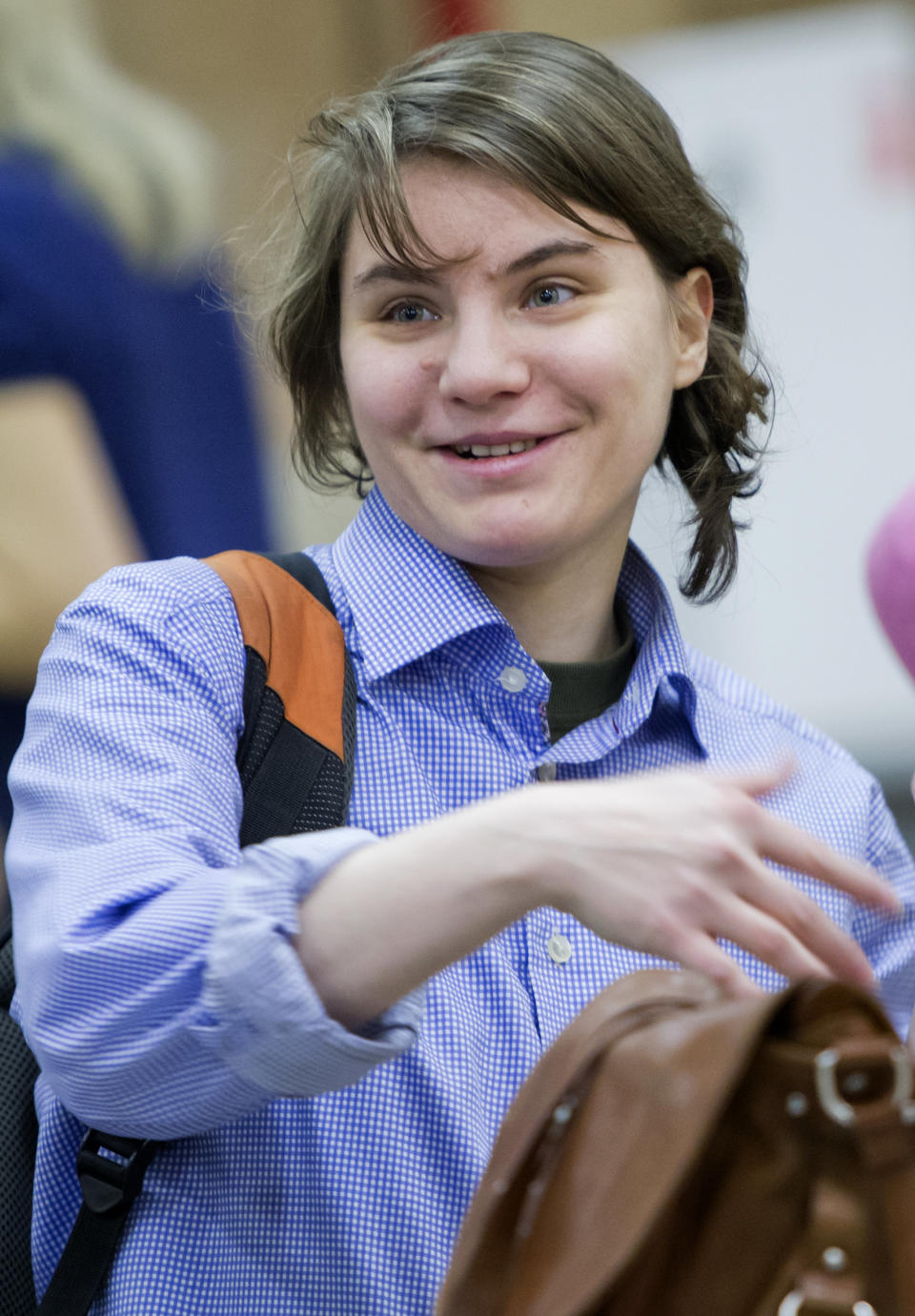 Member of the Pussy Riot punk band Yekaterina Samutsevich smiles as she attends a session at the Moscow City Court where she is appealing to overturn a court's decision to ban the video of the band's "punk prayer" in Moscow's main cathedral as "extremist", Russia, Thursday, Jan. 24, 2013. (AP Photo/Misha Japaridze)