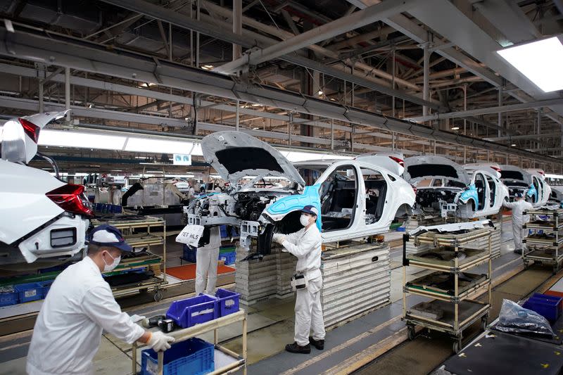 Employees work on a production line inside a Dongfeng Honda factory in Wuhan