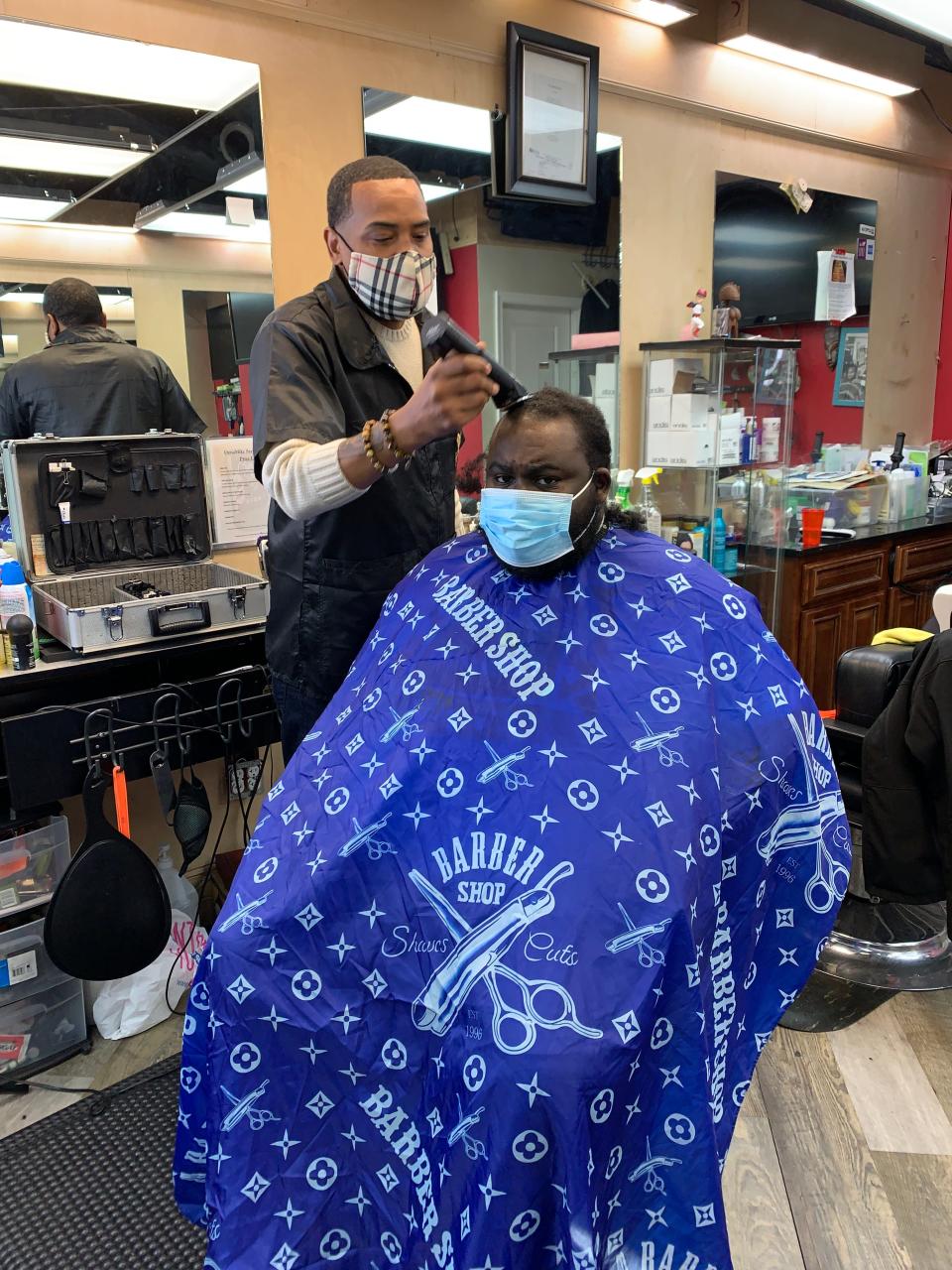 Mike Brown, who runs a barber shop in a strip mall in Hyattsville, Maryland, has been combating conspiracy theories about the COVID vaccines spreading on social media like Facebook, Instagram, Twitter and YouTube.