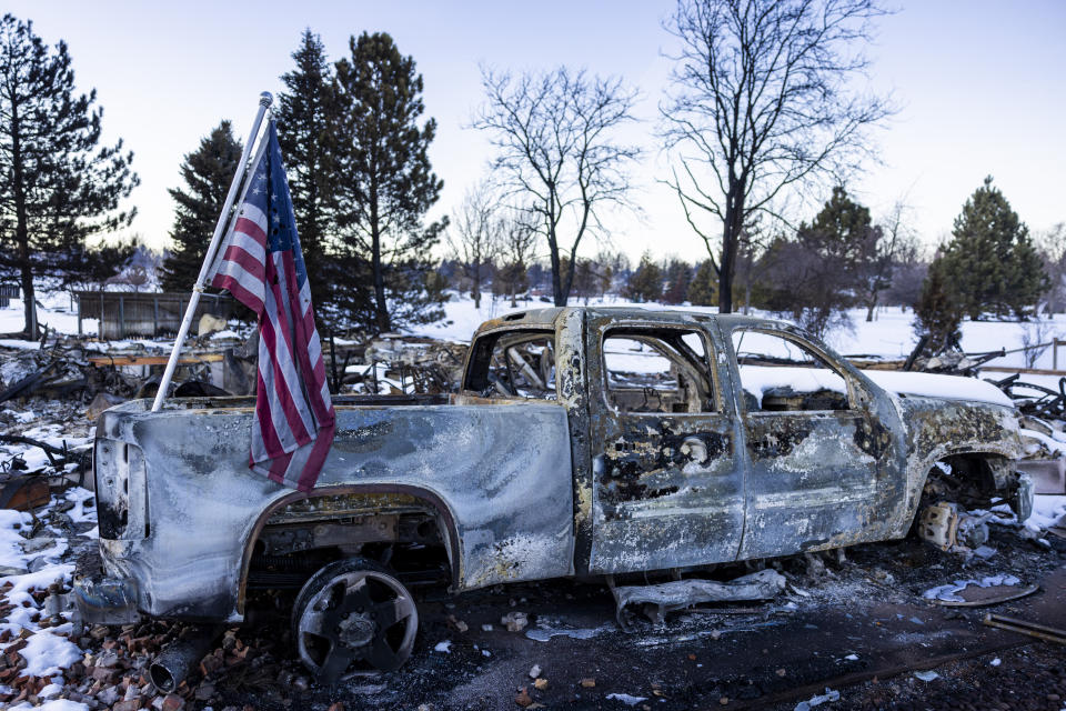 LOUISVILLE, CO - JANUARY 02: An American flag sits on a burned truck in a neighborhood decimated by the Marshall Fire on January 2, 2022 in Louisville, Colorado. Officials reported that 991 homes were destroyed, making it the most destructive wildfire in Colorado history. (Photo by Michael Ciaglo/Getty Images)