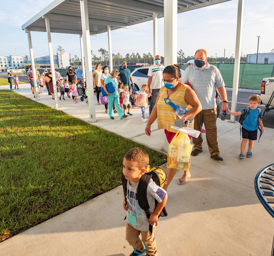 Students and parents arrive for the first day of classes ever at the new Walsingham Academy in Panama City Beach on Aug. 10, 2021.