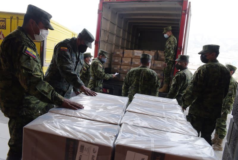 Soldiers unload boxes containing electoral material at a polling station ahead of Ecuador's presidential election on February 7, in Quito