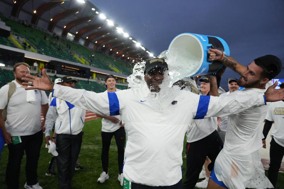 Jun 10, 2022; Eugene, OR, USA; Florida Gators coach Mike Holloway is doused by Jacob Miley after the Gators won the men's team title during the NCAA Track and Field Championships at Hayward Field. Mandatory Credit: Kirby Lee-USA TODAY Sports