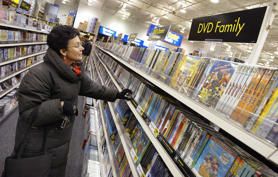 Best Buy's DVD collection with a customer browsing