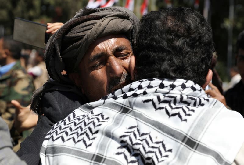 A Houthi fighter hugs a relative upon his arrival at Sanaa Airport after his release in a prisoner swap