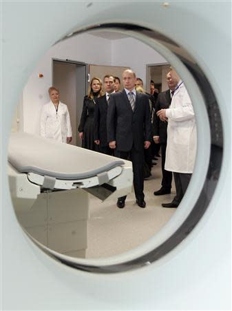 Then Russia's President Vladimir Putin (C) and Russia's First Deputy Prime Minister and presidential candidate Dmitry Medvedev (3rd L) inspect a new Hi-tech cordial centre in Penza city 700 km (435 miles) from Moscow, in this January 23, 2008 file photo. REUTERS/Sergei Karpukhin/Files