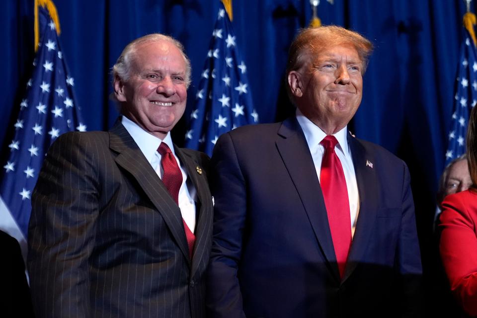 Republican presidential candidate former President Donald Trump stands on stage with South Carolina Gov. Henry McMaster at a primary election night party at the South Carolina State Fairgrounds in Columbia, S.C., Saturday, Feb. 24, 2024. (AP Photo/Andrew Harnik)