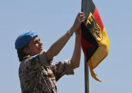 A German navy U.N. peacekeeper sets the German flag on the UNIFIL German vessel, during preparation for the visit of the German Defense Minister Ursula von der Leyen, in the seaport of Beirut, Lebanon, Thursday, April 24, 2014. Leyen is in Lebanon to meet with Lebanese officials and to visit the German UNIFIL navy troops. Germany has been a contributor since 2006 to the UNIFIL maritime mission in Lebanon which aims at supporting the Lebanese navy in securing Lebanon’s maritime borders. (AP Photo/Hussein Malla)