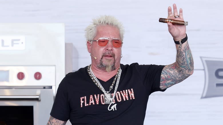 Guy Fieri in Flavortown shirt with cigar