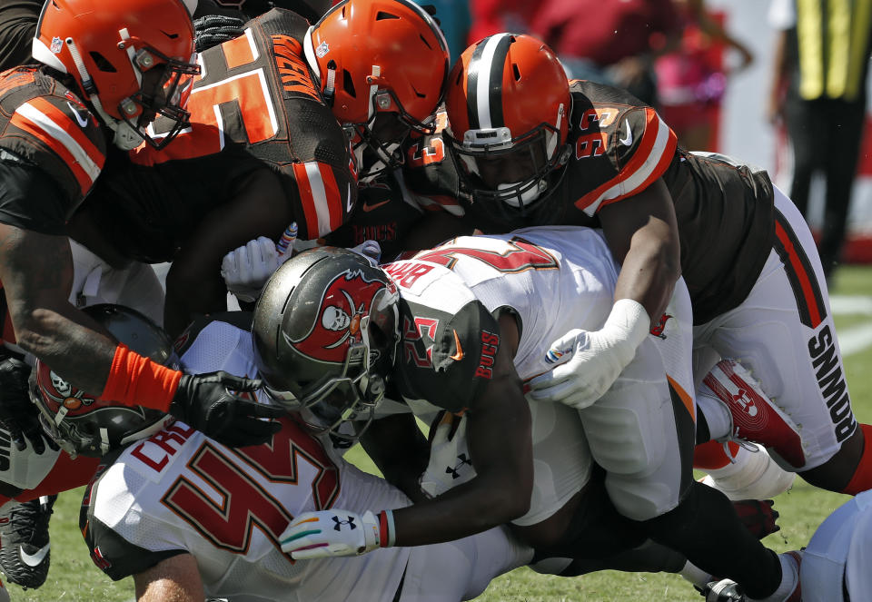 Cleveland Browns defensive tackle Trevon Coley (93) takes down Tampa Bay Buccaneers running back Peyton Barber (25) in the endzone for a safety during the first half of an NFL football game Sunday, Oct. 21, 2018, in Tampa, Fla. (AP Photo/Mark LoMoglio)