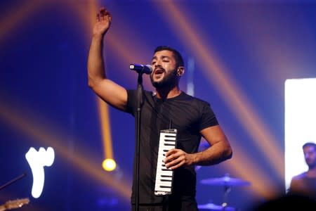 FILE PHOTO: Sinno, lead singer of Lebanese alternative rock band Mashrou' Leila performs with his band during a concert in Beirut