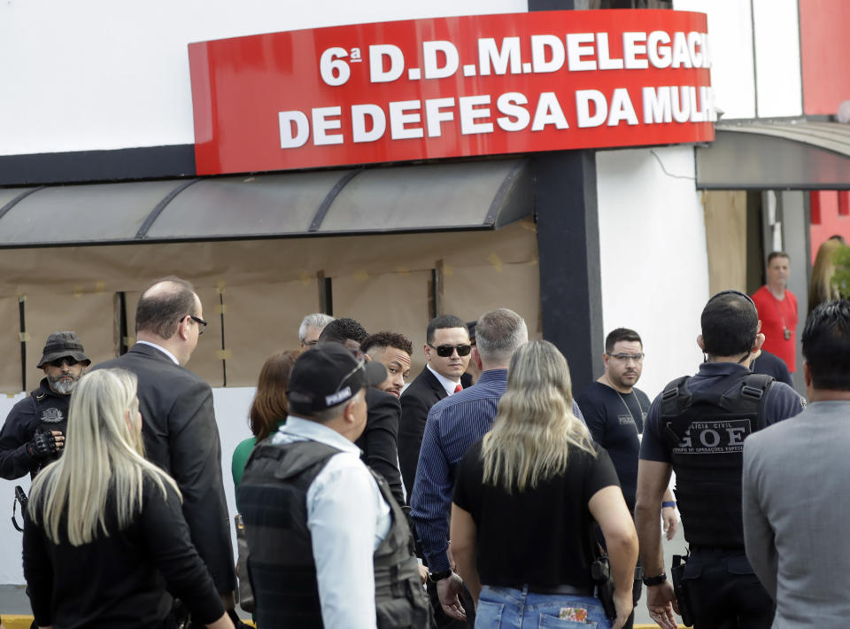 Brazilian soccer star Neymar, center, arrives to a police station to testify, after a woman accused him of rape, in Sao Paulo, Brazil, Thursday, June 13, 2019. Neymar denies any wrongdoing. (AP Photo/Andre Penner)