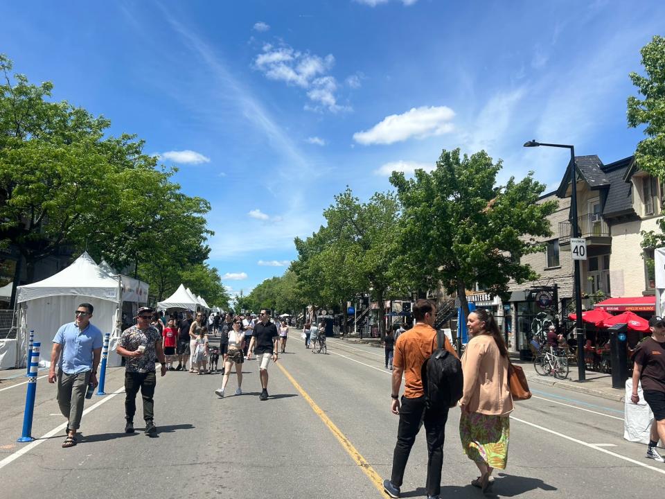 people milling about st denis street in Montreal on a nice day