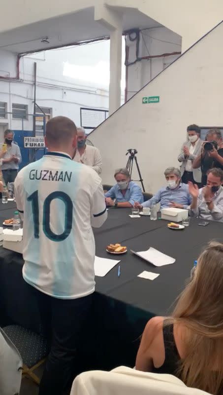 Argentine Economy Minister Martin Guzman receives a national team soccer jersey in San Martin, outside Buenos Aires