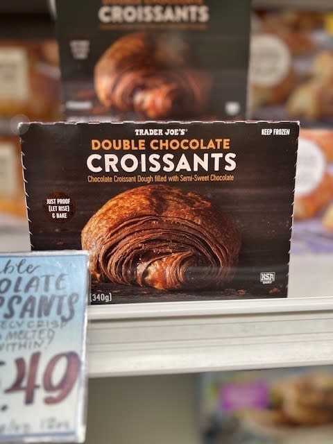 Package of Trader Joe's Double Chocolate Croissants on a store shelf with price tag visible