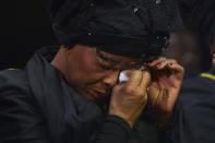 Graca Machel, widow of former South African President Nelson Mandela, wipes her tears during the funeral ceremony of Nelson Mandela in Qunu December 15, 2013. REUTERS/Odd Andersen/Pool (SOUTH AFRICA - Tags: SOCIETY OBITUARY POLITICS)