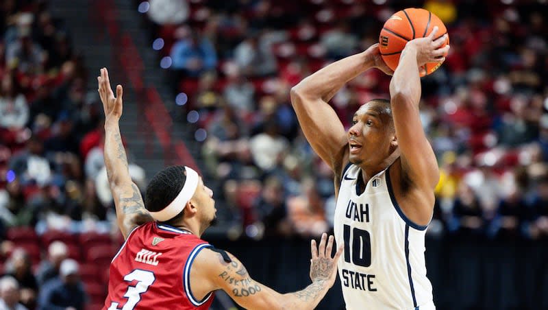 Utah State Aggies guard Darius Brown II (10) looks for a teammate to pass the ball to with Fresno State Bulldogs guard Isaiah Hill (3) on defense during the game between the Utah State Aggies and the Fresno State Bulldogs in the quarterfinals of the Mountain West 2024 men's basketball championship at the Thomas & Mack Center in Las Vegas on Thursday, March 14, 2024.