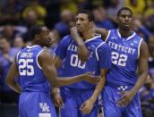 Kentucky's Alex Poythress (22), Marcus Lee (00) and Dominique Hawkins (25) celebrate during the second half of an NCAA Midwest Regional final college basketball tournament game against Michigan Sunday, March 30, 2014, in Indianapolis. (AP Photo/David J. Phillip)