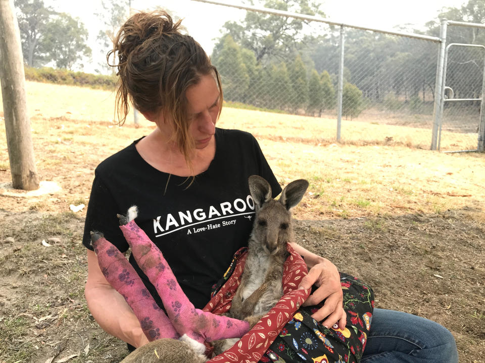 Wildlife Information, Rescue and Education Services (WIRES) Volunteer and carer Tracy Dodd holds a kangaroo with burnt feet pads after being rescued from bushfires in Australia's Blue Mountains area, December 30, 2019.   REUTERS/Jill Gralow