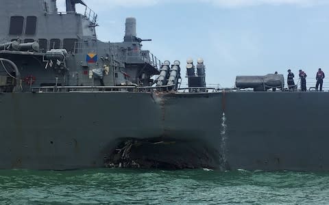 USS John S. McCain seen after a collision, in Singapore waters  - Credit: Reuters