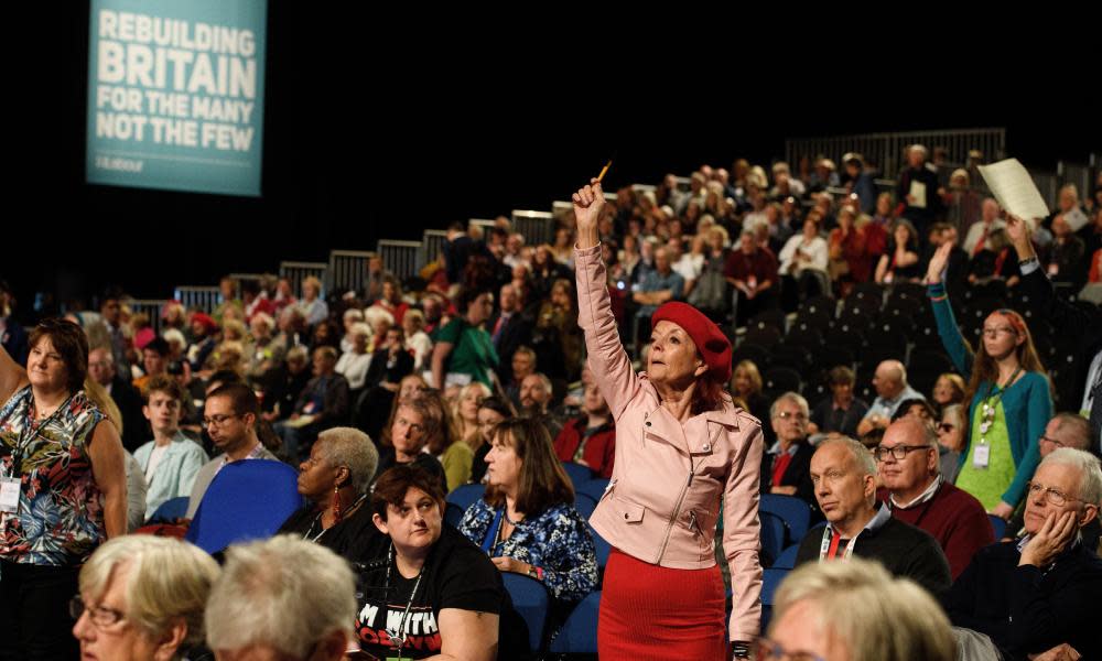 Delegates raise their hands during a debate on day two of the Labour party conference in Liverpool.