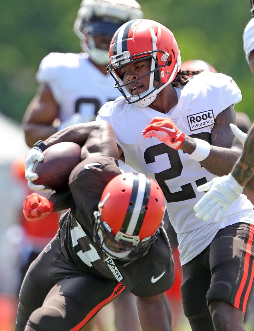 Cleveland Browns cornerback Martin Emerson Jr. punches the ball away from wide receiver Donovan Peoples-Jones during the NFL football team's football training camp in Berea on Tuesday.