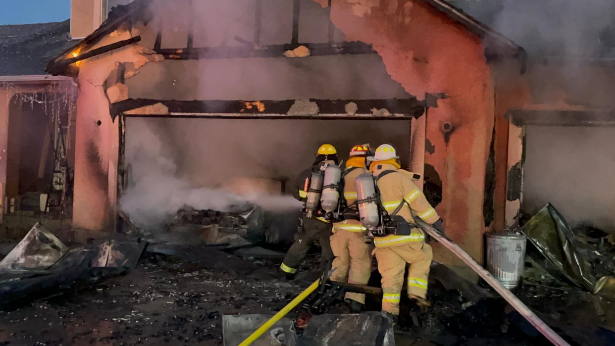Pueblo West firefighters subdue the blaze in a garage on Meriweather Drive on Monday night.