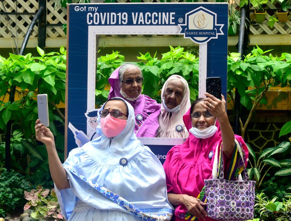 MUMBAI, INDIA  MARCH 16: Senior citizens taking pictures at a selfie point after being administered a Covid-19 vaccine at Saifee Hospital, Marine Lines on March 16, 2021 in Mumbai, India. (Photo by Anshuman Poyrekar/Hindustan Times via Getty Images)