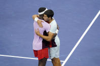 Carlos Alcaraz, of Spain, right, embraces Frances Tiafoe, of the United States, after defeating him in the semifinals of the U.S. Open tennis championships, Friday, Sept. 9, 2022, in New York. (AP Photo/Mary Altaffer)