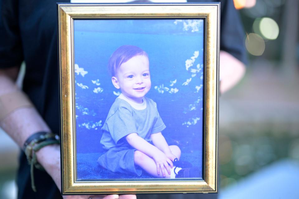 Brandon Wade's aunt Mary hold a photo of him as a toddler.